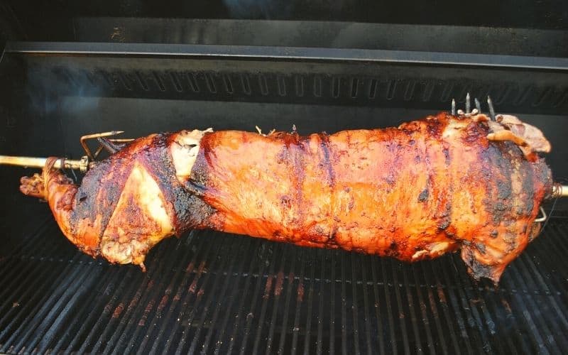 a whole pig on a rotisserie