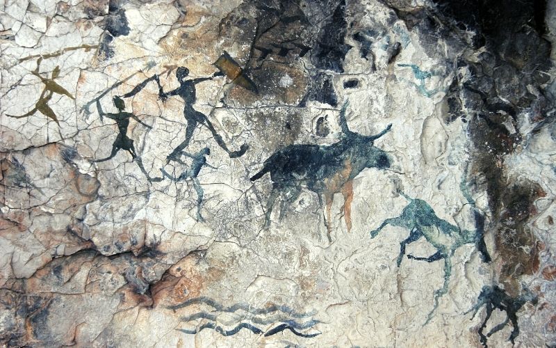 cave painting with hunters
