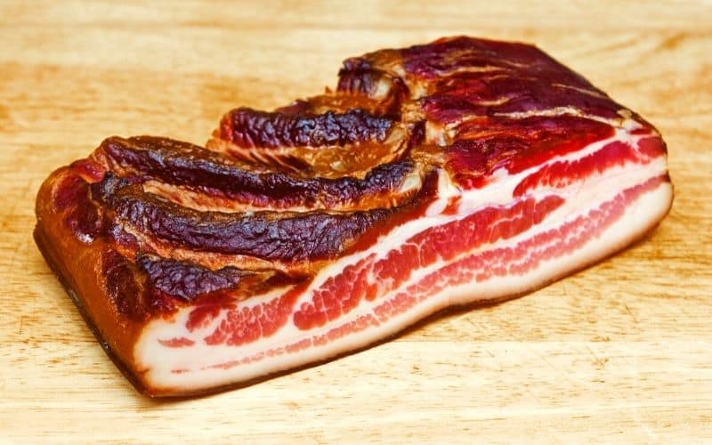 a piece of cold smoked pork belly