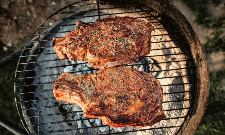steaks on a charcoal grill