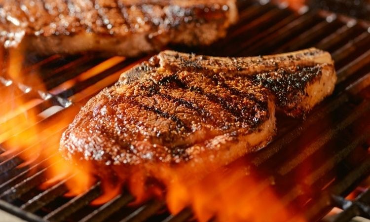 ribeye steaks on a hot grill