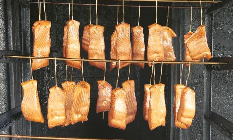 salmon fillets being smoked