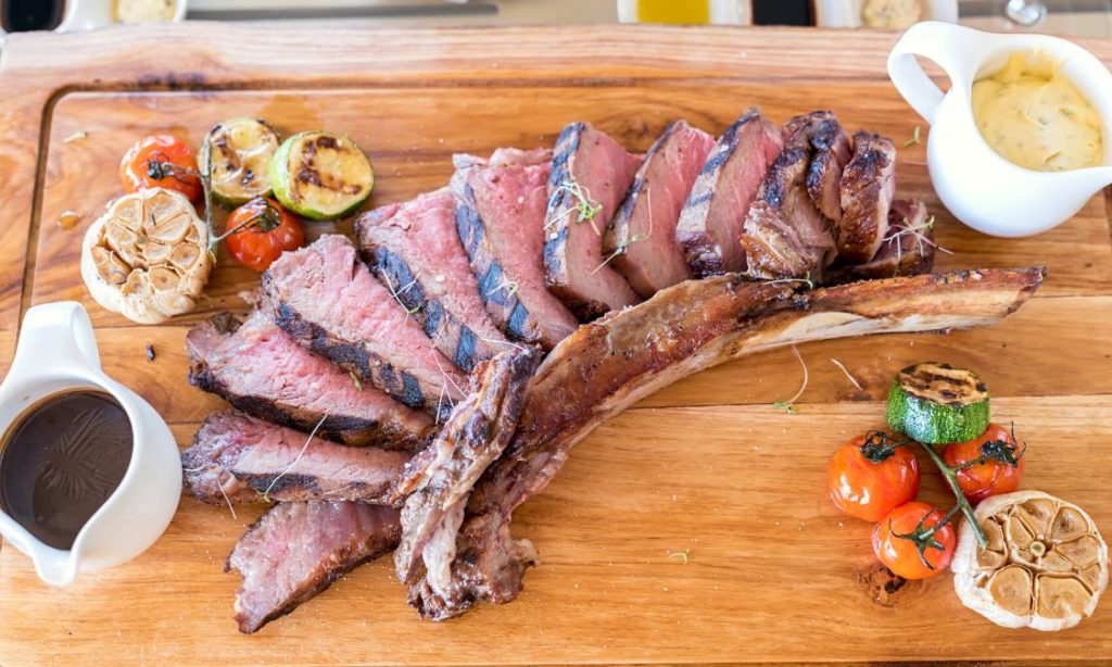 grilled tomahawk steak with butter and sauce